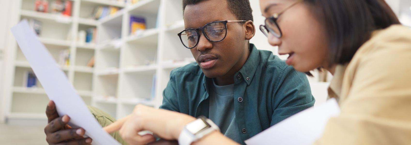 Students looking at paper